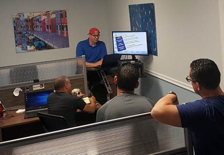 The CarChat24 team enjoys training in its new Tampa Bay area office.